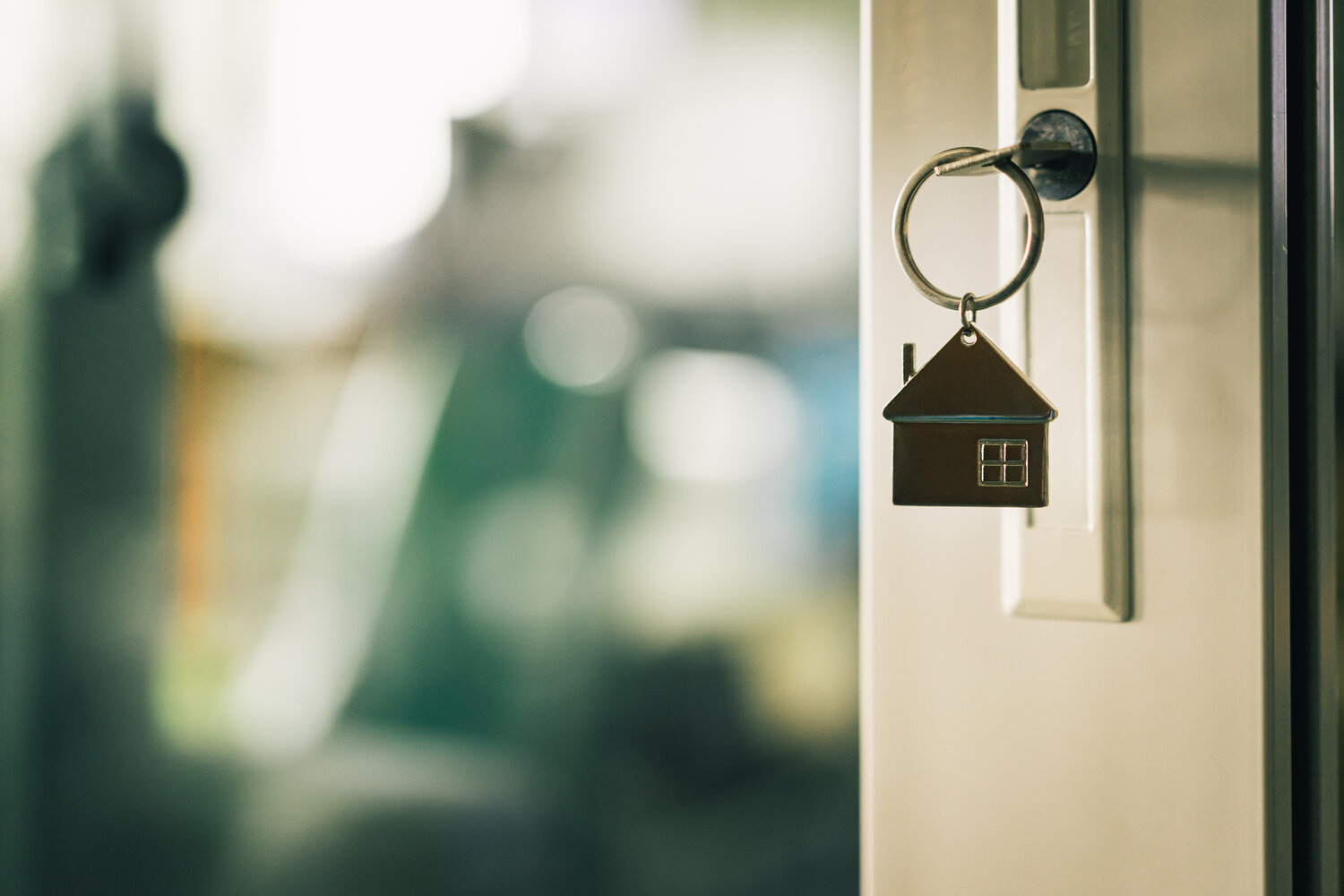 House model and key in house door. Real estate agent offer house, property insurance and security, affordable housing concepts